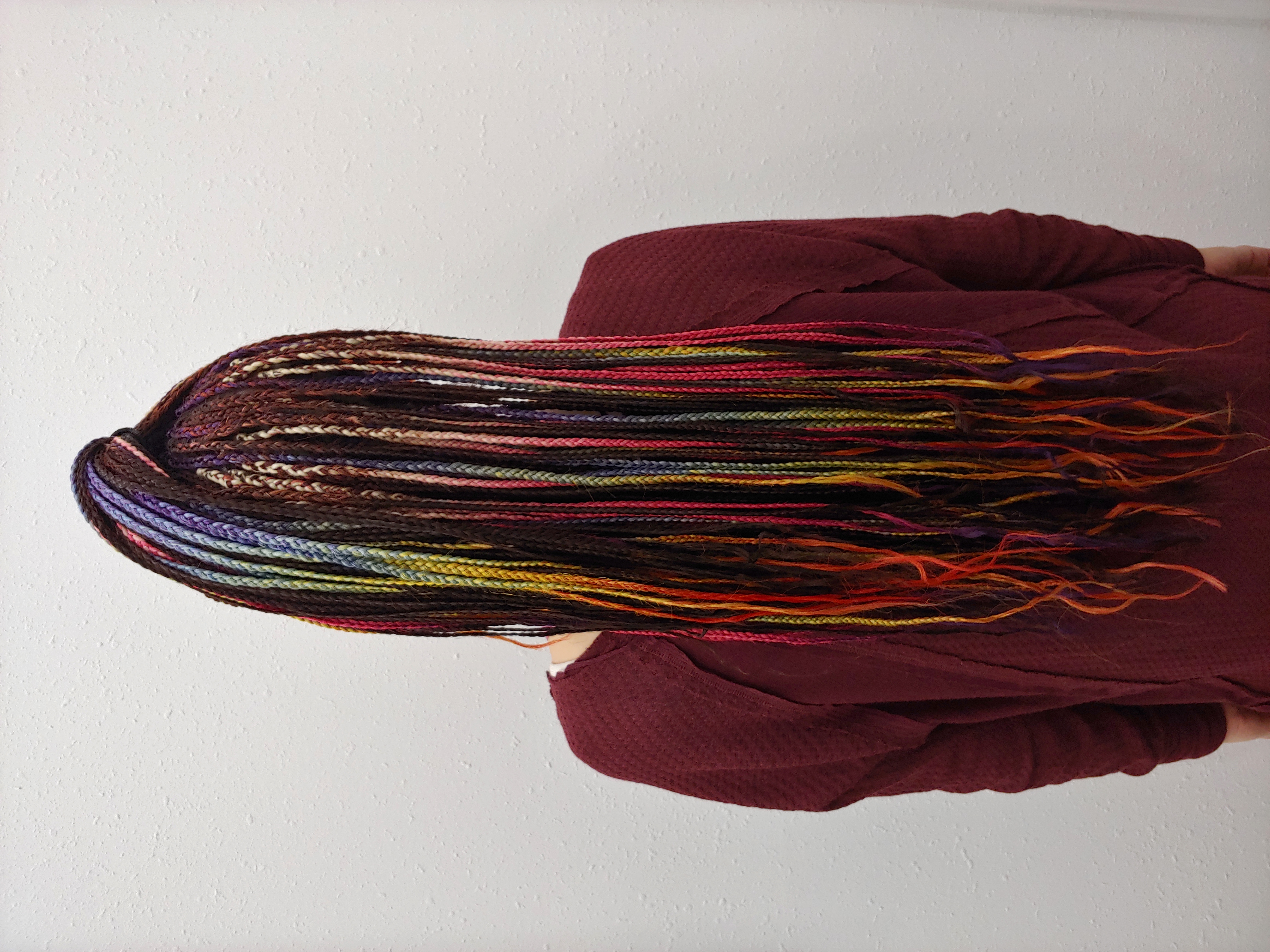 Colorful cornrow braids styled by Angel Hair Braids Beverly Hills